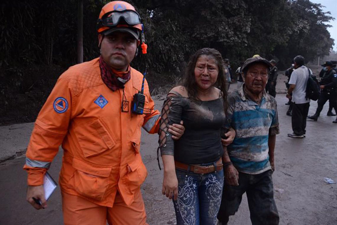 Trabalhador ajuda no resgate de moradores atingidos pela erupção do Vulcão Fogo/Noe Pérez/EFE/direitos reservados