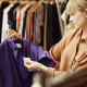 Woman choosing clothes in store --- Image by © Tabor Gus/Corbis